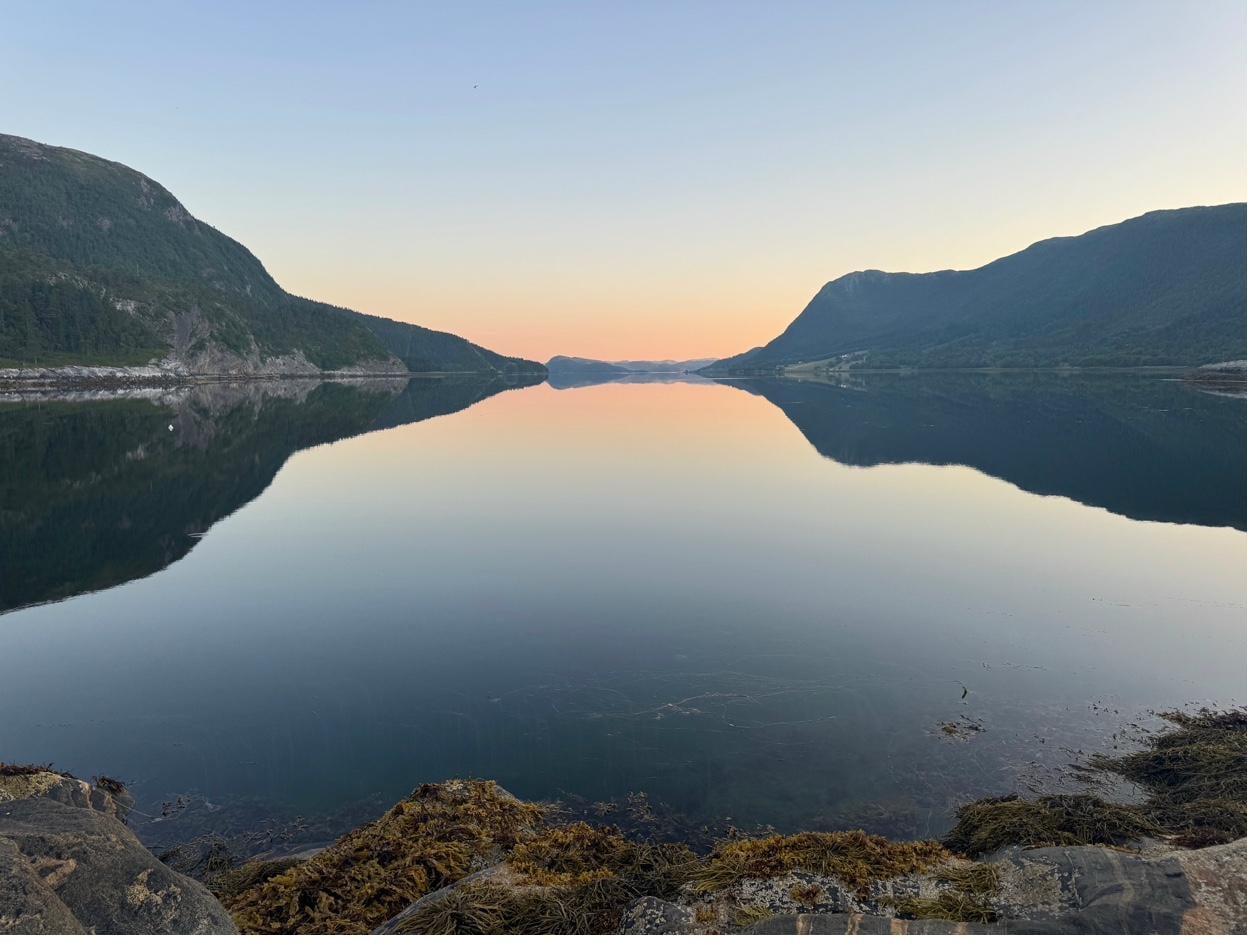 Dramatic orange and pink sunset over the Norwegian fjord